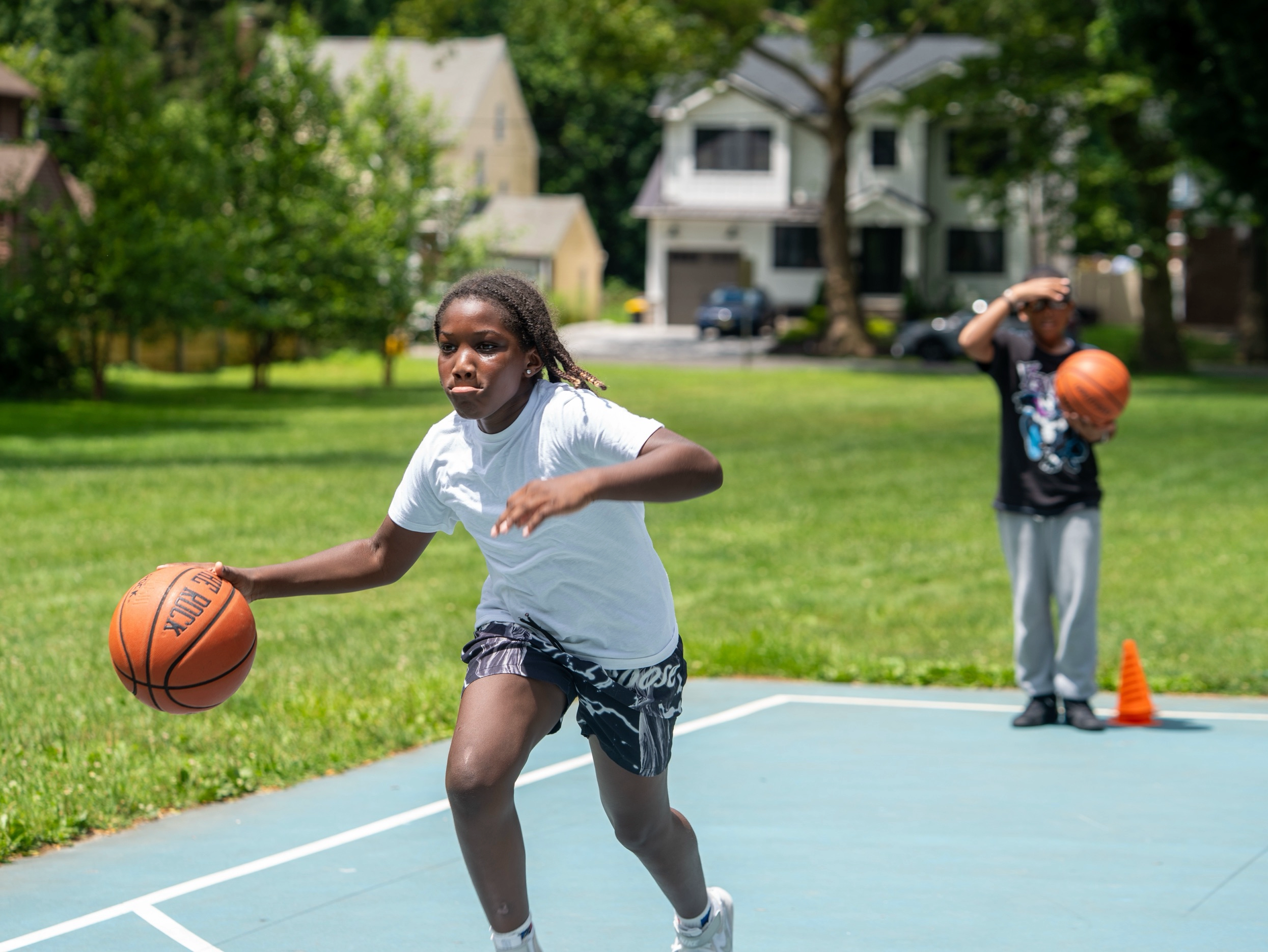 Youth athletes working agility hurdles at Teaneck sports performance camp